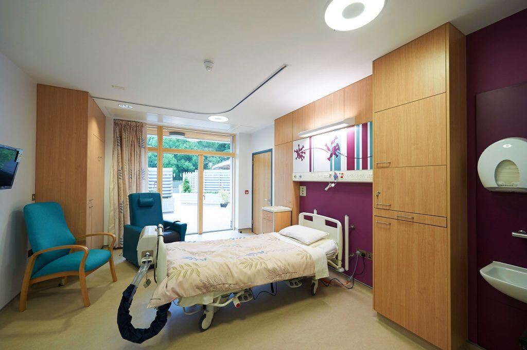 Kirkwood Hospice patient bedroom with bed and 2 chairs